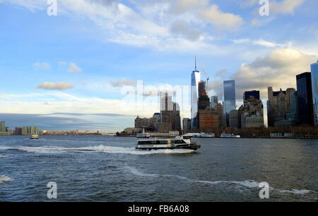 Moving NY Waterway ferry and early morning view of the New York skyline on the East River, New York City, New York, USA Stock Photo