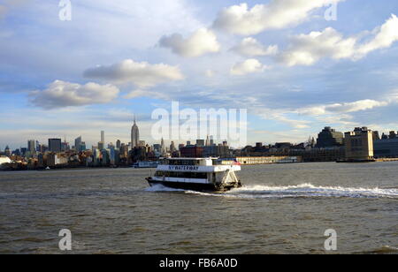 Moving New York Waterway ferry and early morning view of the New York skyline on the East River, New York City, New York, USA Stock Photo