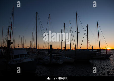 Boats docked at Newport Harbor at sunset, Newport, Rhode Island, United States of America Stock Photo