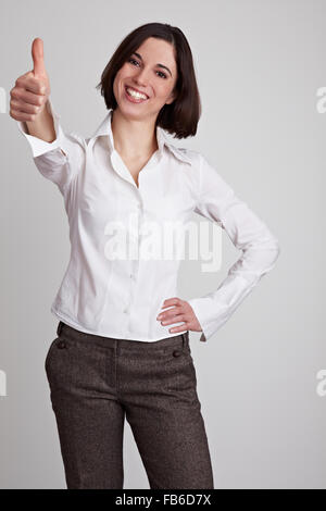 Happy smiling business woman holds her thumb up Stock Photo
