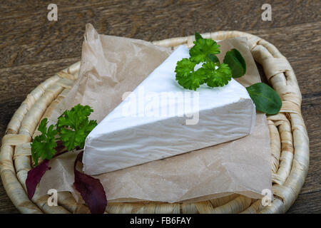 Soft brie cheese served parsley leaves on wooden background Stock Photo ...