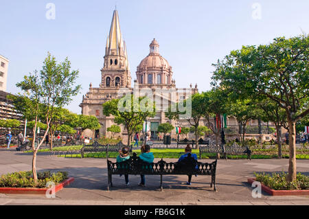 People relaxing in the square (plaza) near the Metropolitana Caatedral (cathedral) in Guadalajara, Mexico Stock Photo