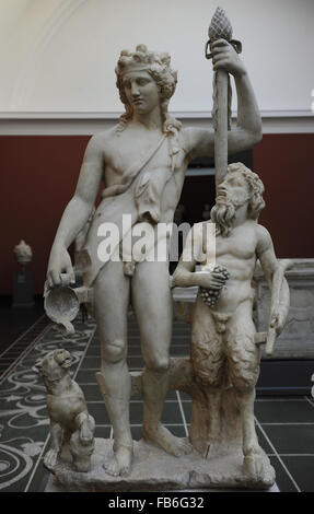 Bacchus (Roman) also known as Dionysus (Greek). God of the grape harvest in classical mythology. Statue of Bacchus with satyr and panther. From roman Villa of Pozzuoli, near Naples, Italy. 2nd century AD. Marble. Ny Carlsberg Glyptotek. Copenhagen, Denmark. Stock Photo