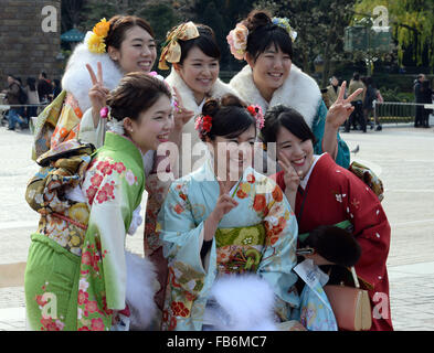 Tokyo, Japan. 11th Jan, 2016. Japanese girls wearing kimonos pose for pictures at Disneyland in Tokyo, Japan, Jan. 11, 2016. People who turned 20-year-old took part in the annual Coming-of-Age Day ceremony in Japan on Monday. © Ma Ping/Xinhua/Alamy Live News Stock Photo