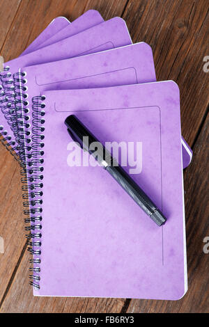 stack of notebooks and fountain pen on the table Stock Photo