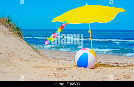 colored ball under a yellow parasol Stock Photo