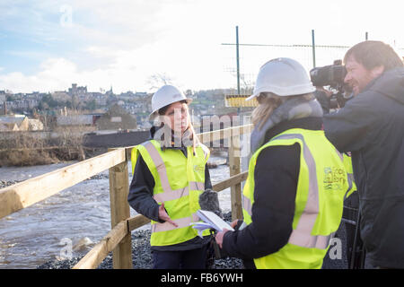 Selkirk, UK. 11th January, 2016.   First ever national flood plan for Scotland  Minister, Dr Aileen McLeod, on site at the Selkirk Flood Protection works, faces questions from the media.  Flood risk management strategy launch, Environment Minister Dr Aileen McLeod today visited Selkirk Flood Protection Scheme (11 January, 2016) to launch the national flood risk management plan for Scotland. Dr McLeod met with representatives from SEPA and the local council to discuss partnership working to prevent flooding in local areas.  Credit:  Rob Gray/Alamy Live News Stock Photo