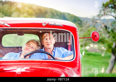 Senior couple in red car Stock Photo