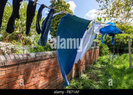 Washing line with drying clothes in outdoor. Clothes hanging on washing line  in outdoor Stock Photo - Alamy