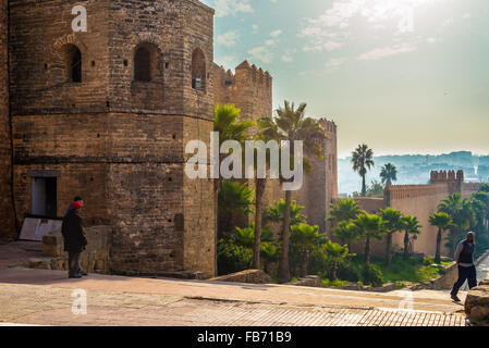 Youths front of walls of Kasbah of the Udayas. Is a small fortified complex and a symbol of the Almohad arquitecture, Rabat. Stock Photo