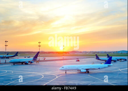 View of Airplanes at airport in the beautiful sunset Stock Photo