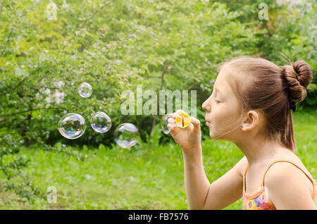 Portrait of the girl who are starting up soap bubbles Stock Photo
