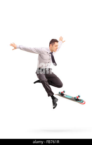 Full length portrait of a young businessman performing tricks with a skateboard shot in mid-air isolated on white background Stock Photo