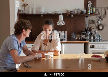 Young couple sitting at dining table Stock Photo