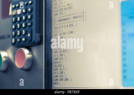 Display of programmable machine with big red button. Milling and lathe industry. CNC technology. Metal engineering. shallow DOF Stock Photo