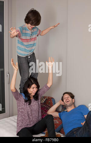 Boy having fun with parents Stock Photo