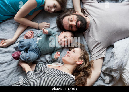 High angle view of family relaxing on bed Stock Photo