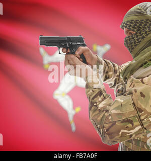 Man with gun in hand and national flag on background series - Isle of Man Stock Photo