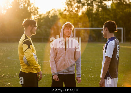 Young soccer players standing on field Stock Photo