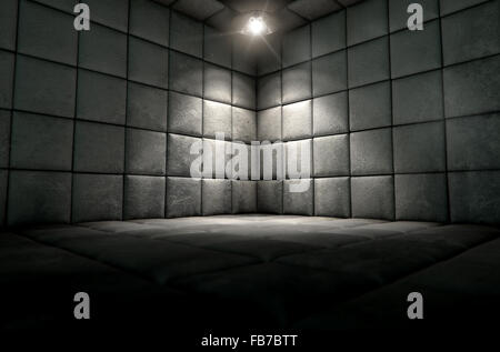 A dark dirty white padded cell in a mental hospital with a corner lit by a single spotlight