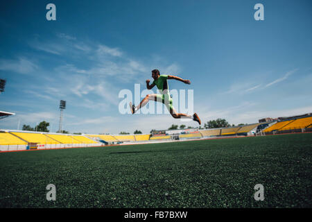 Full length of sporty young man running in stadium during training Stock Photo