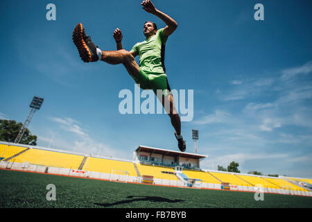 Full length of young athlete running in stadium during training Stock Photo