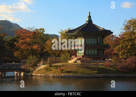 Photographer takes picture of Hyangwonjeong Pavilion in sunset, Seoul, South Korea. Stock Photo