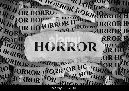 Torn pieces of paper with the word «Horror». Concept Image. Black and White. Closeup. Stock Photo