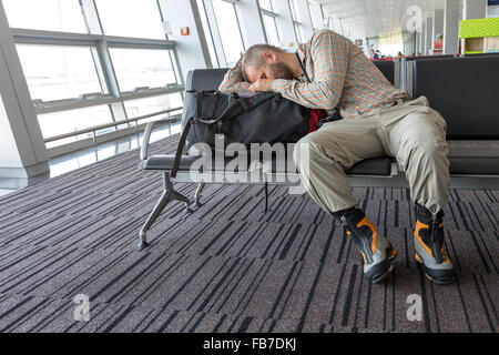 Sleeping man inside transport terminal Stock Photo