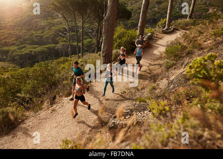 Group of runners in a cross country race. Young people running in nature. Trail running workout. Stock Photo
