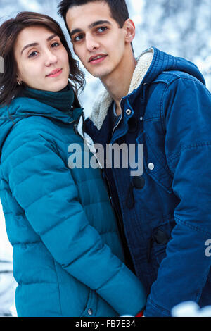 Loving young couple in warm clothing looking away Stock Photo