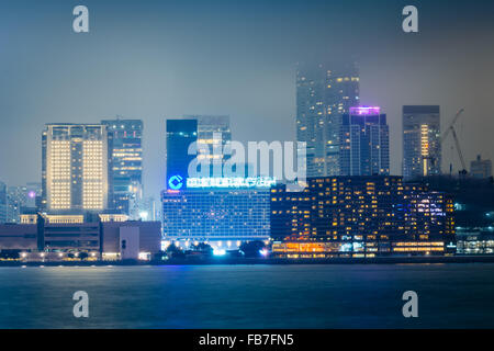 View of the skyline of Tsim Sha Tsui at night, seen from the Expo Promenade in Hong Kong, Hong Kong. Stock Photo