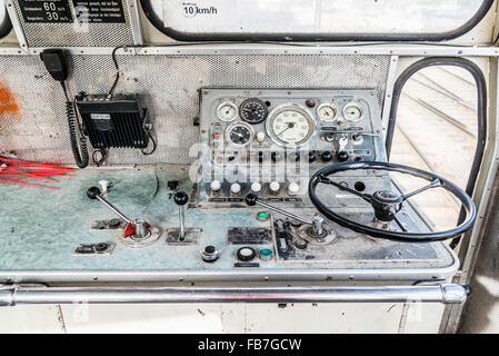 Steering wheel and control panel in train Stock Photo