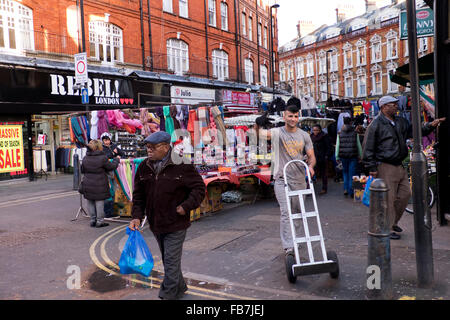 People shopping in Brixton West Indian outdoor market Lambeth South London Stock Photo