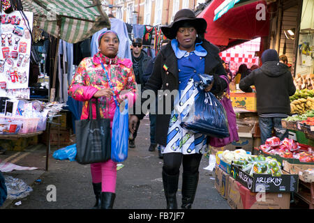 People shopping in Brixton West Indian outdoor market Lambeth South London Stock Photo