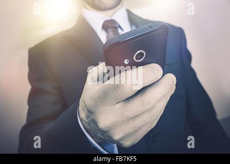 Business Phone Call. Businessman Making a Call Using His New Smartphone Device. Business Communication Concept. Stock Photo