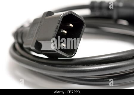 Black power cord with detail on the C14 (IEC320) connector on a white background. Stock Photo