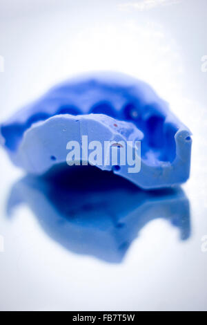 Dental prosthetics clay tooth mold in dentists photo. Stock Photo