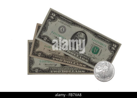 US dollars and silver liberty coin Stock Photo