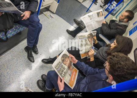 London, UK. 11th January, 2016. Reading on news on tube of the death of David Bowie Credit:  Marcus Tylor/Alamy Live News Stock Photo