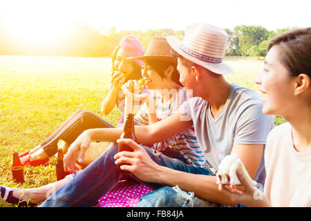 happy young friends enjoying picnic and eating Stock Photo