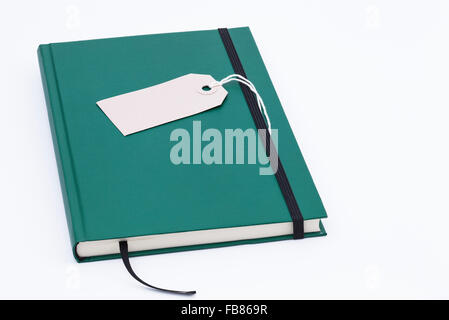 Image shows a green notebook isolated on white background Stock Photo