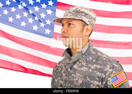 US military man standing in front of an American flag Stock Photo