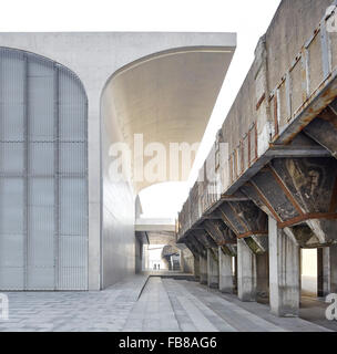 Vaulted concrete columns juxtaposed to derelict loading structure. Long Museum West Bund, Shanghai, China. Architect: Atelier De Stock Photo