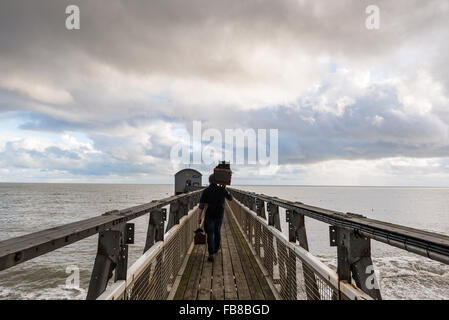 Selsey, West Sussex, UK. 11th January, 2016. Carrying the camera to the boat house. Jack Lowe, who is is photographing every RNLI lifeboat station in the UK using a plate camera and wet collodion process, visits Selsey Lifeboat Station. Credit:  Julia Claxton/Alamy Live News Stock Photo
