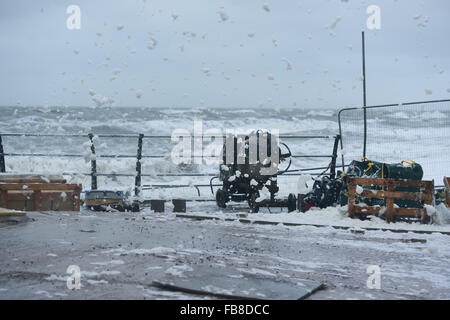 Aberystwyth Wales UK, Tuesday 12 Jan 2015 UK Weather Gale force winds and the 5m high tide at 9.15 am combine to bring streams of sea foam spume blowing like snow blizzards  over the seafront in Aberystwyth on the Cardigan Bay coast in West Wales UK photo Credit:  Keith Morris/Alamy Live News Stock Photo