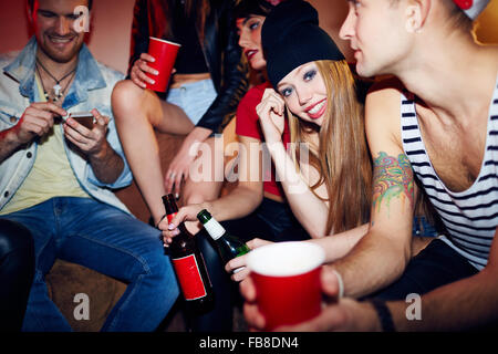 Young friends drinking beer at home Stock Photo