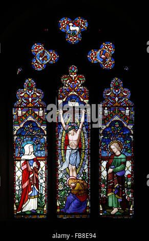 Stained glass window by Lavers Barraud & Westlake  depicting the Crucifixion of Jesus, St Peter's Church, Deene, Northamptonshire Stock Photo
