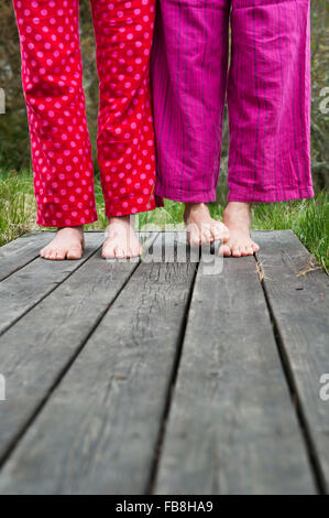 Sweden, Ostergotland, Vikbolandet, Low-section of couple in pajamas Stock Photo
