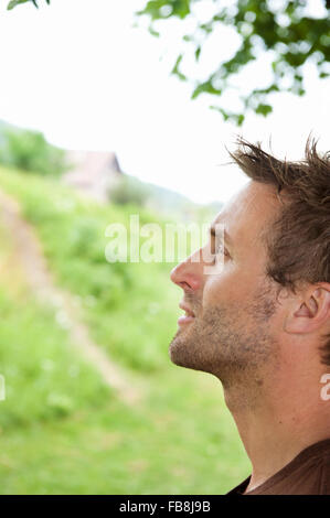 Side profile of a mid adult man holding a fishing rod on the beach Stock  Photo - Alamy